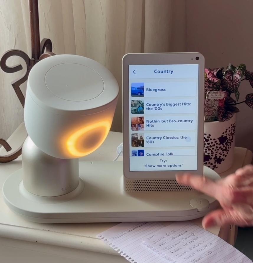 Senior engaging with an AI companion device
